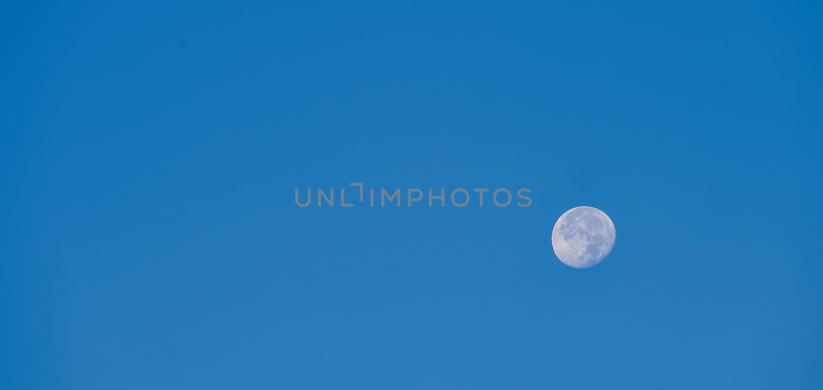 Full moon over blue sky at sunset, France