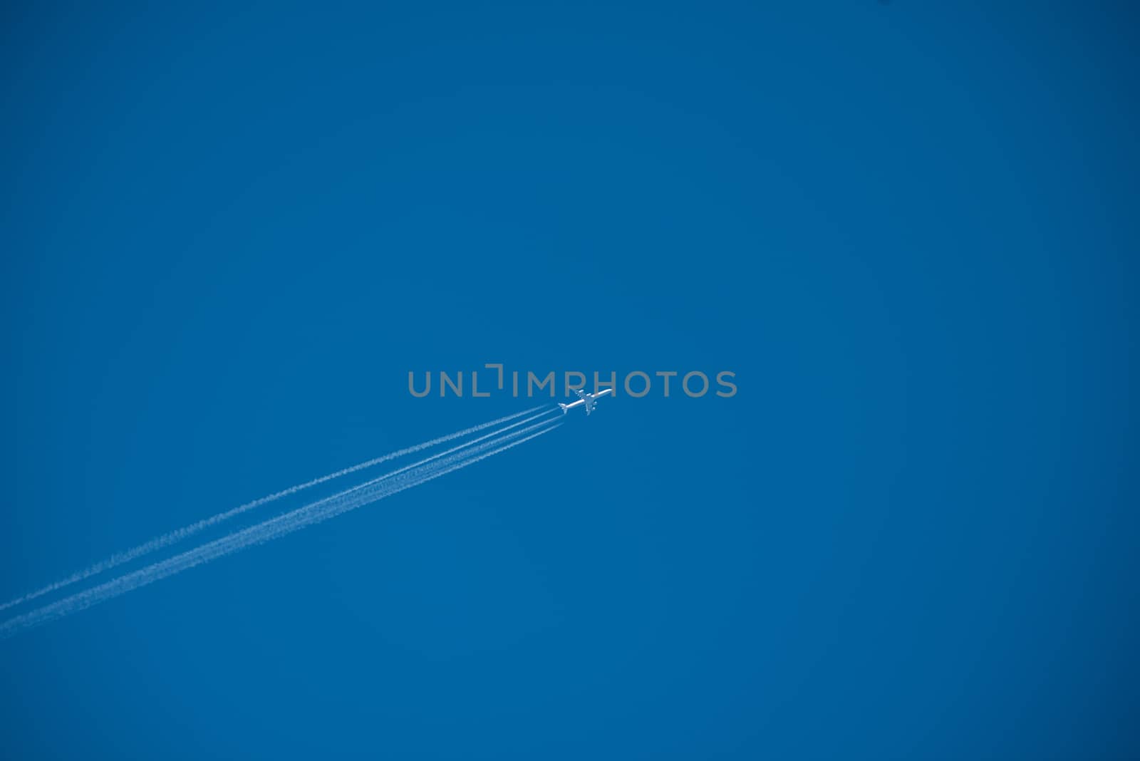 Shot of a jet plane high in the blue sky, France