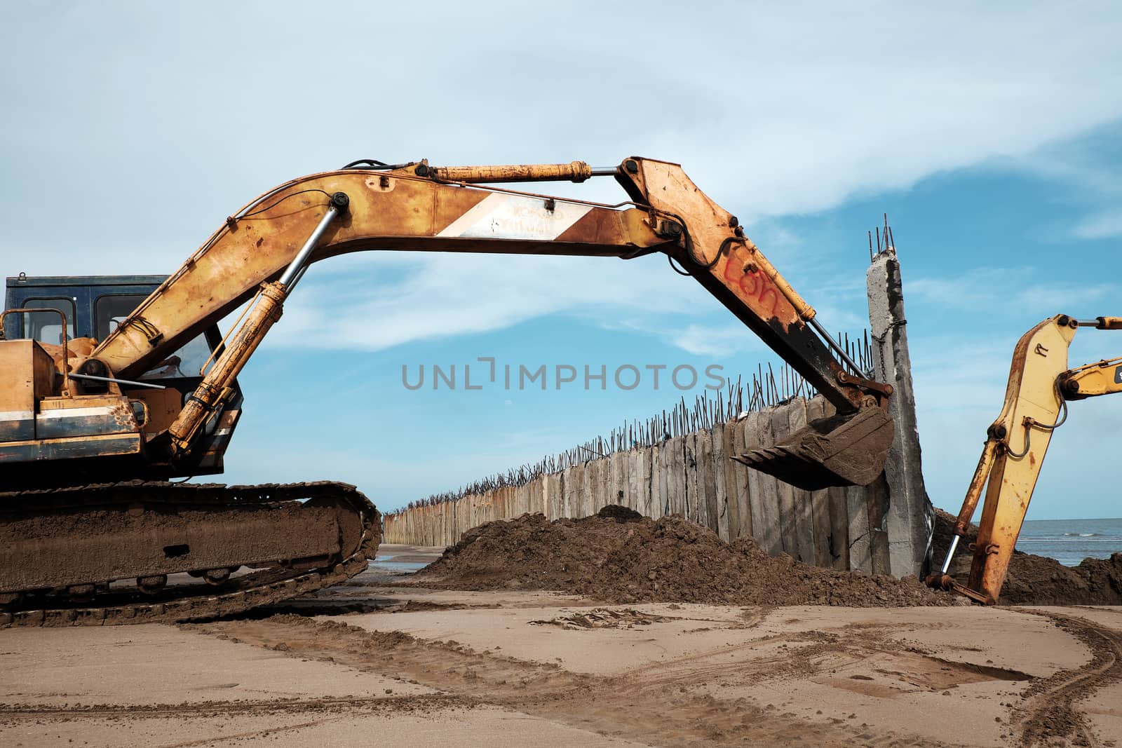  Vietnamese excavator driver control vehicle to build breakwater at beach to protect seaside from erosion at Camau, Vietnam