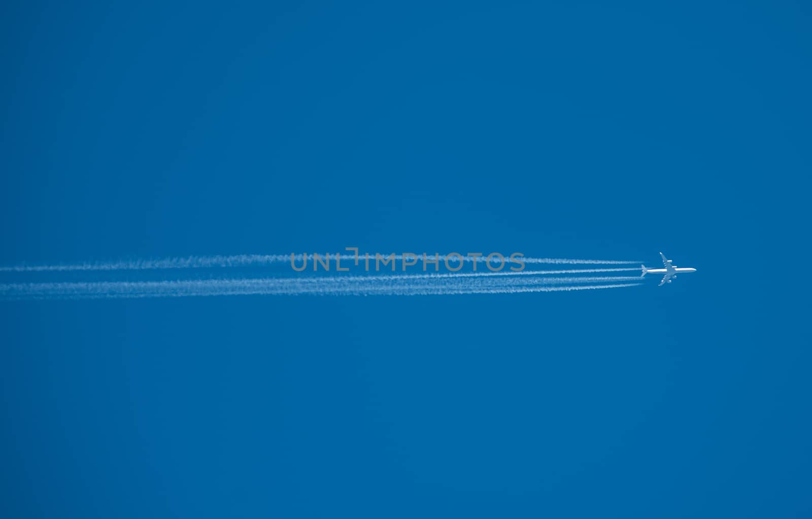 Shot of a jet plane high in the blue sky, France