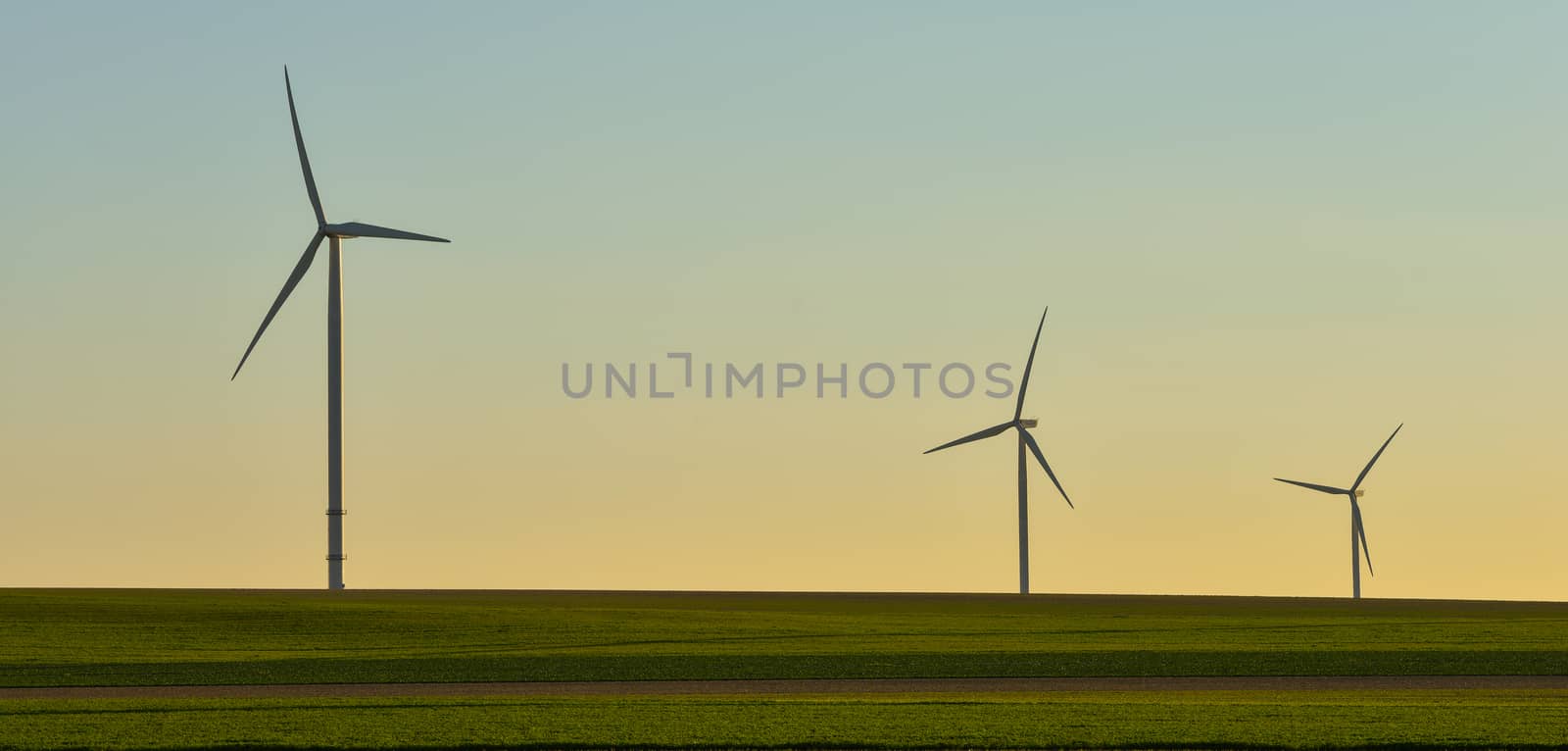 Windmills for electric power production on blue sky, France, Europe