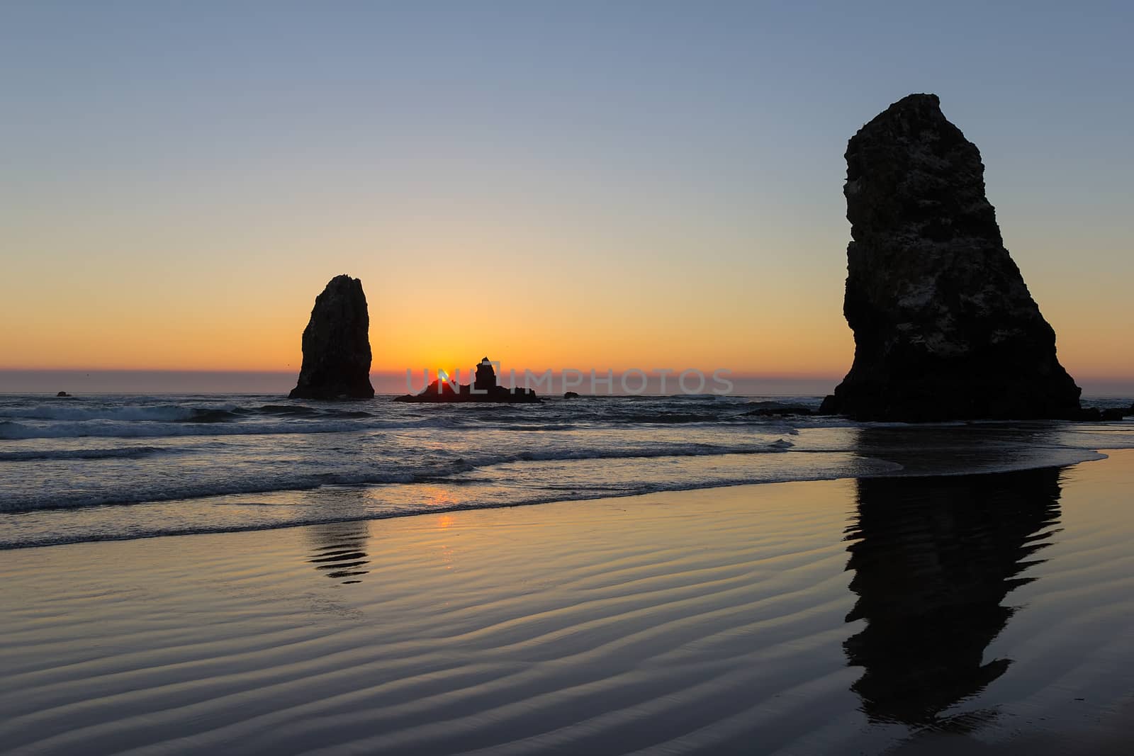 Sunset over the Needles rock formation in Cannon Beach at the Oregon Coast