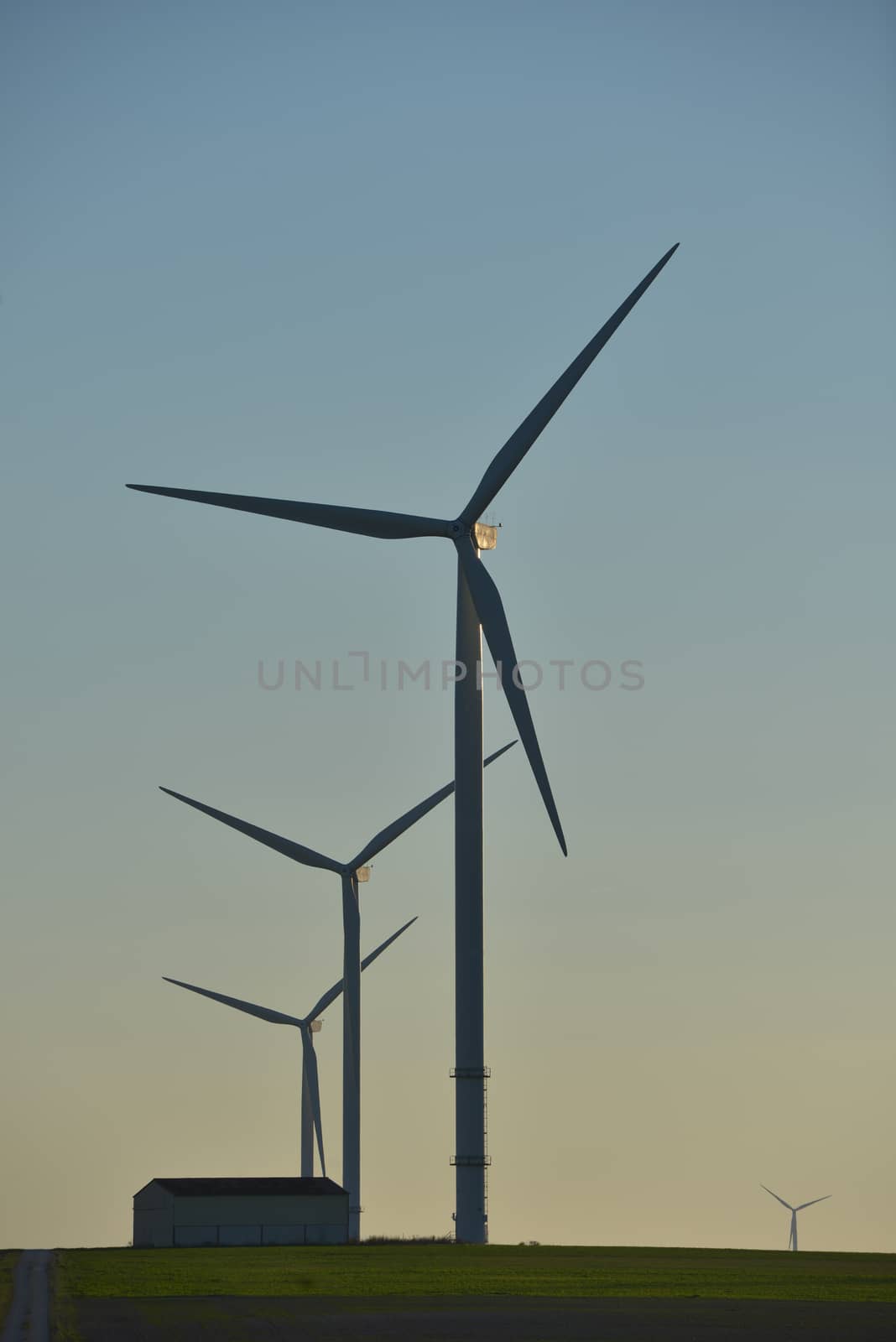 Windmills for electric power production on blue sky, France, Europe