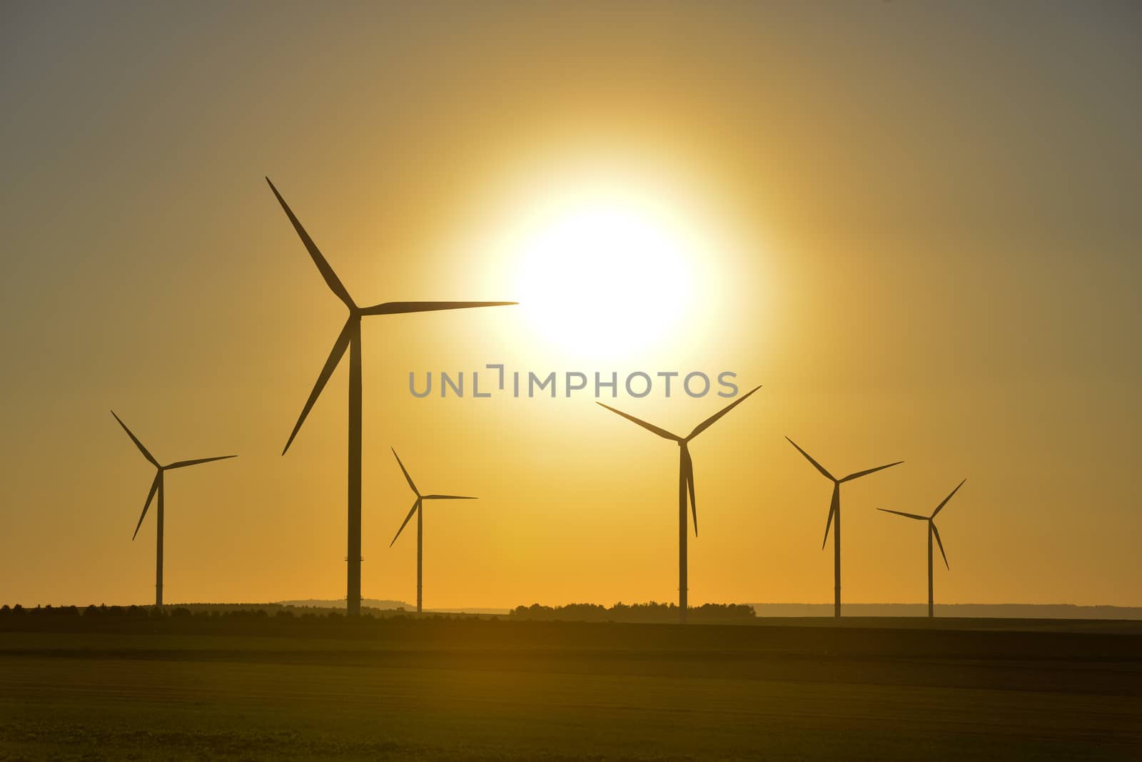 Windwheels and a beautiful sunset seen in rural France, Europe