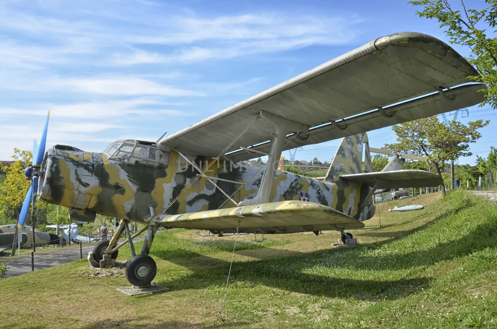 An old Antonov An-2 military aircraft camouflaged