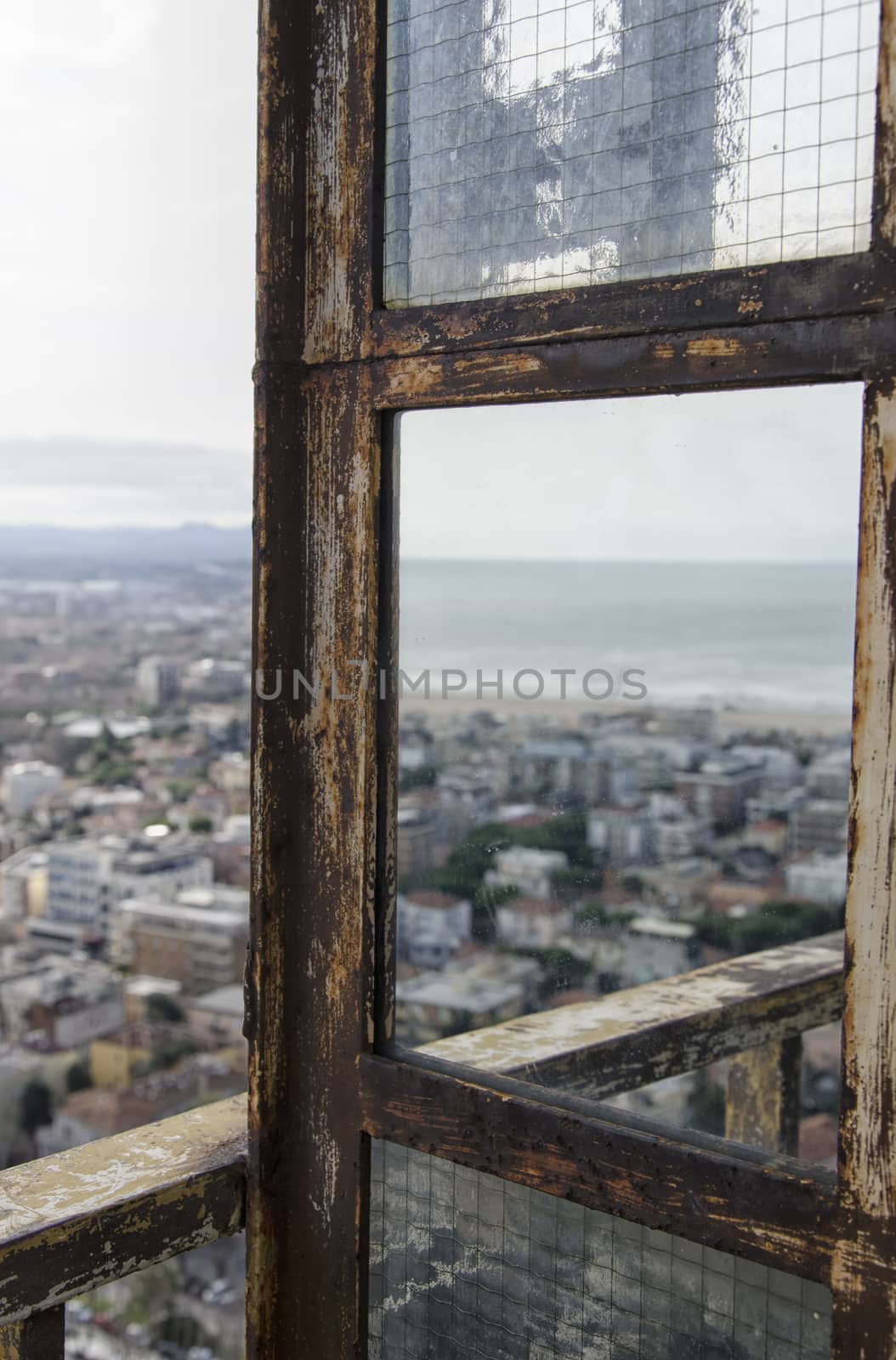 The city of Rimini reflected on a rusty mirror