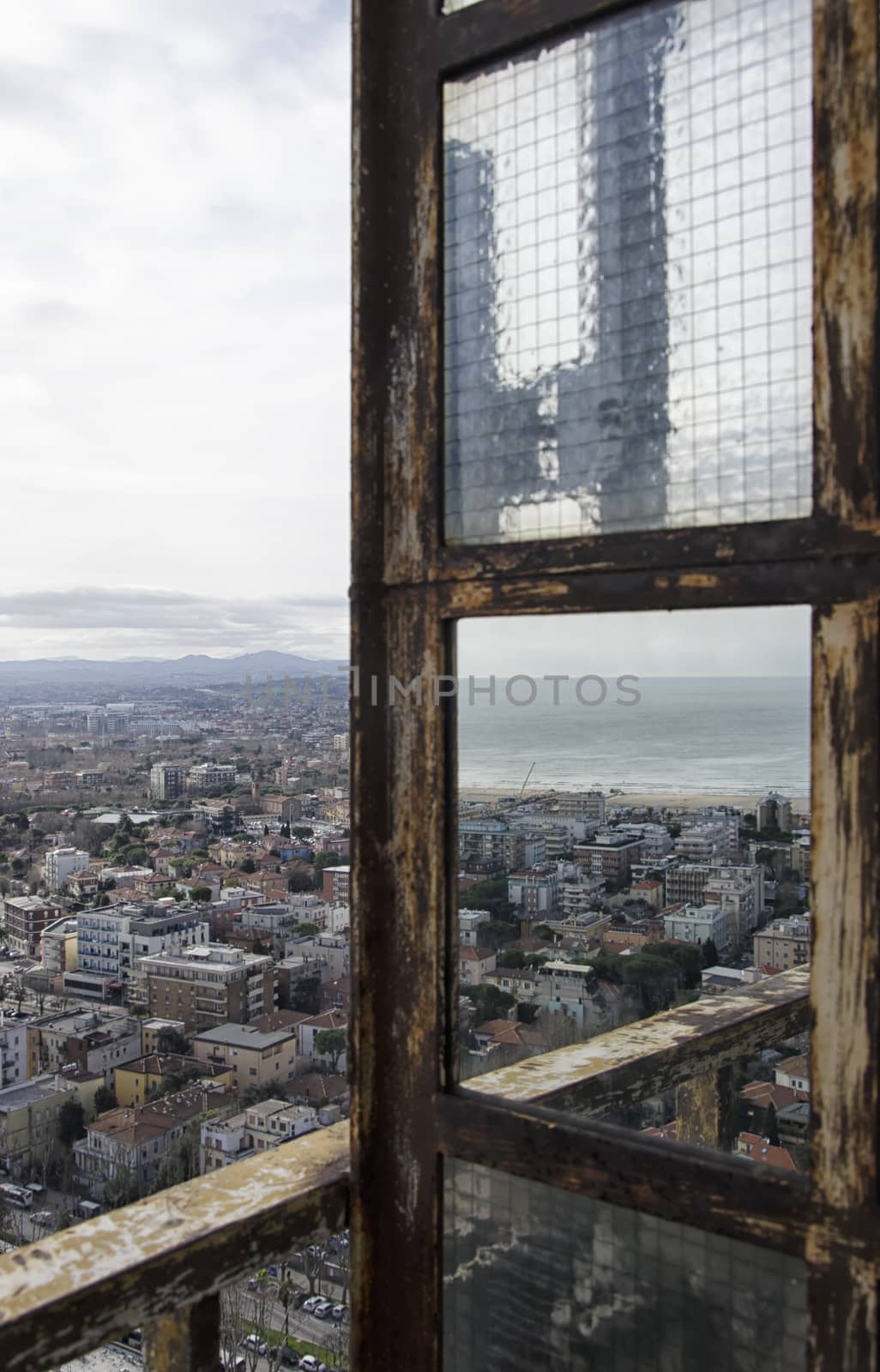 Big city reflected on a rusty mirror