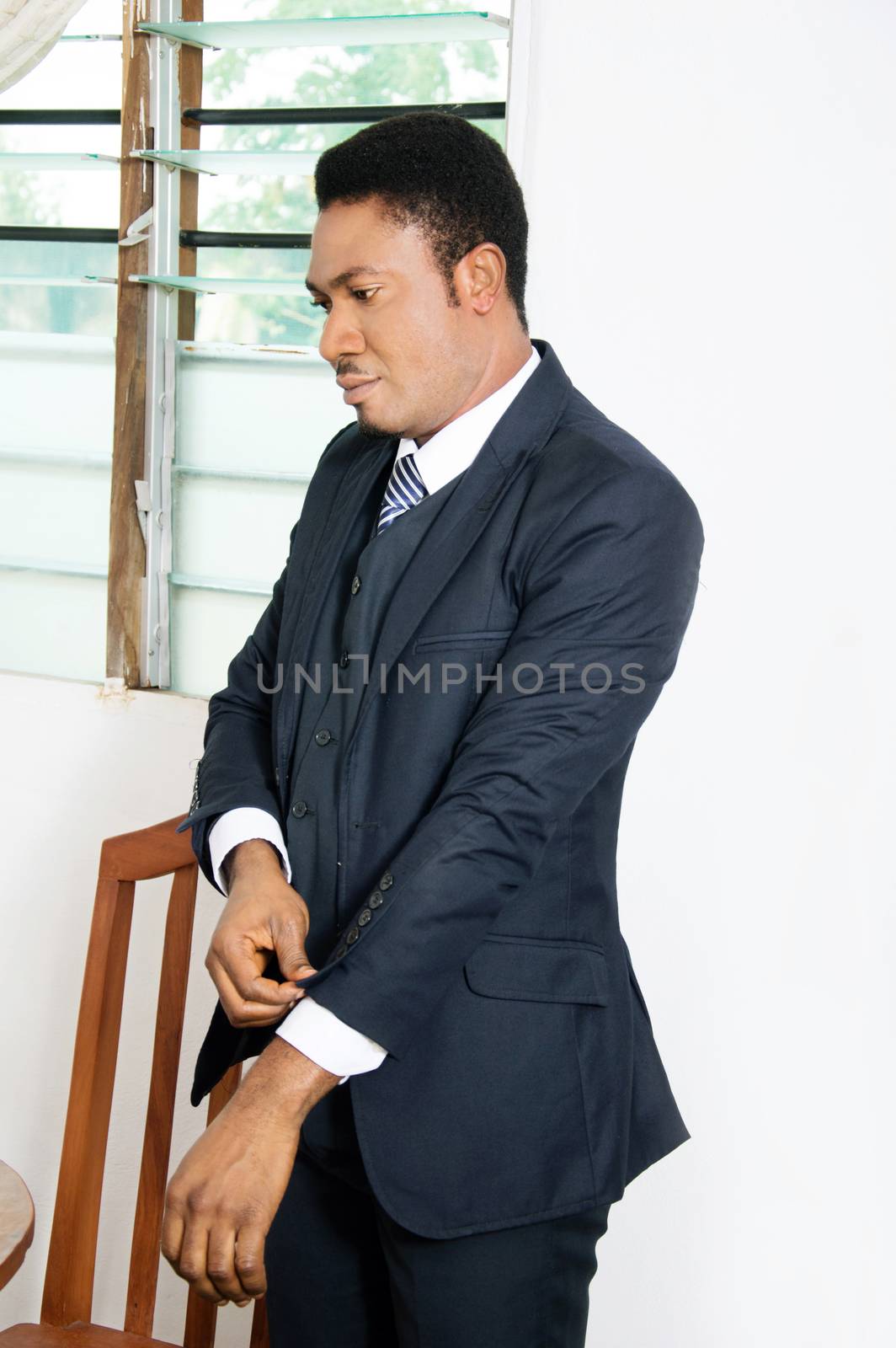 this businessman is being well arrange the sleeve of his suit