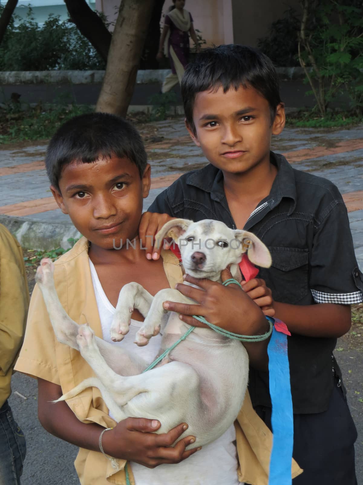 Two Indian boys with their pet dog by thefinalmiracle