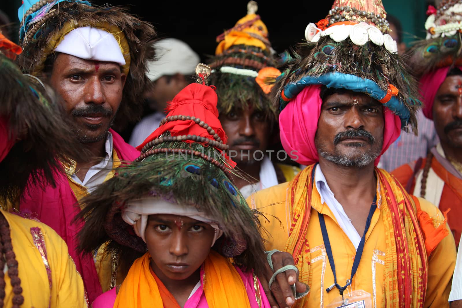 A groups of pilgims traditionally called as Vasudevs wearing their typical peacock feather hat.