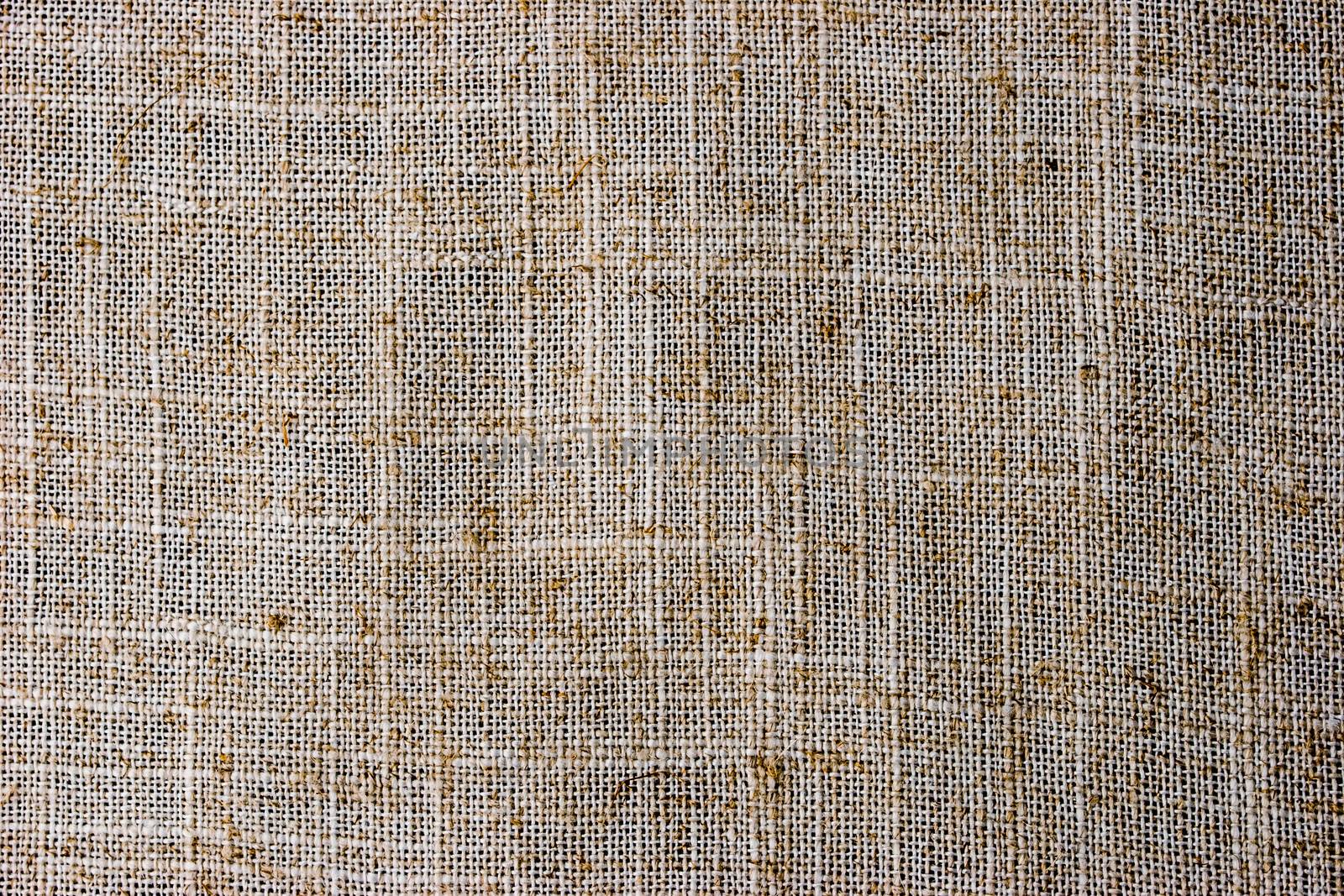 Natural flax napkin background close-up by Deniskarpenkov