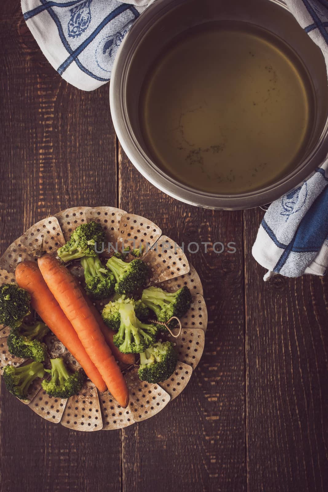 Steamed vegetables on the wooden table top view