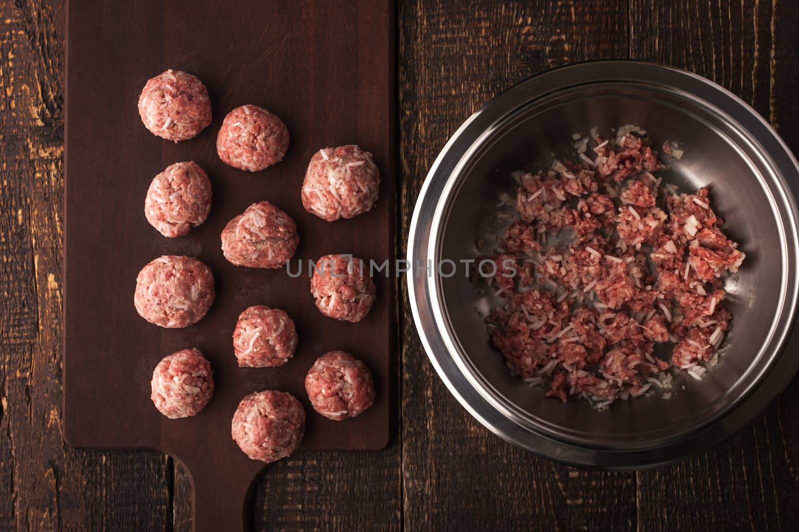 Meatballs on the wooden board with stuffing in a pan top view horizontal
