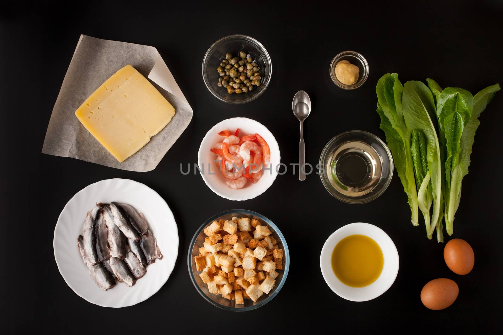 Ingredients for Caesar salad on the black background horizontal
