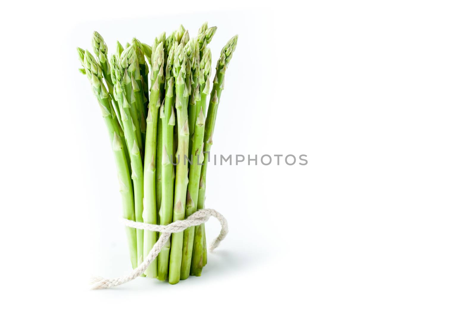 Bundle of asparagus at the left of white background horizontal