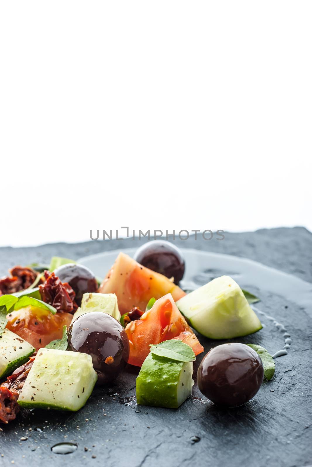 Vegetable salad on the black stone table