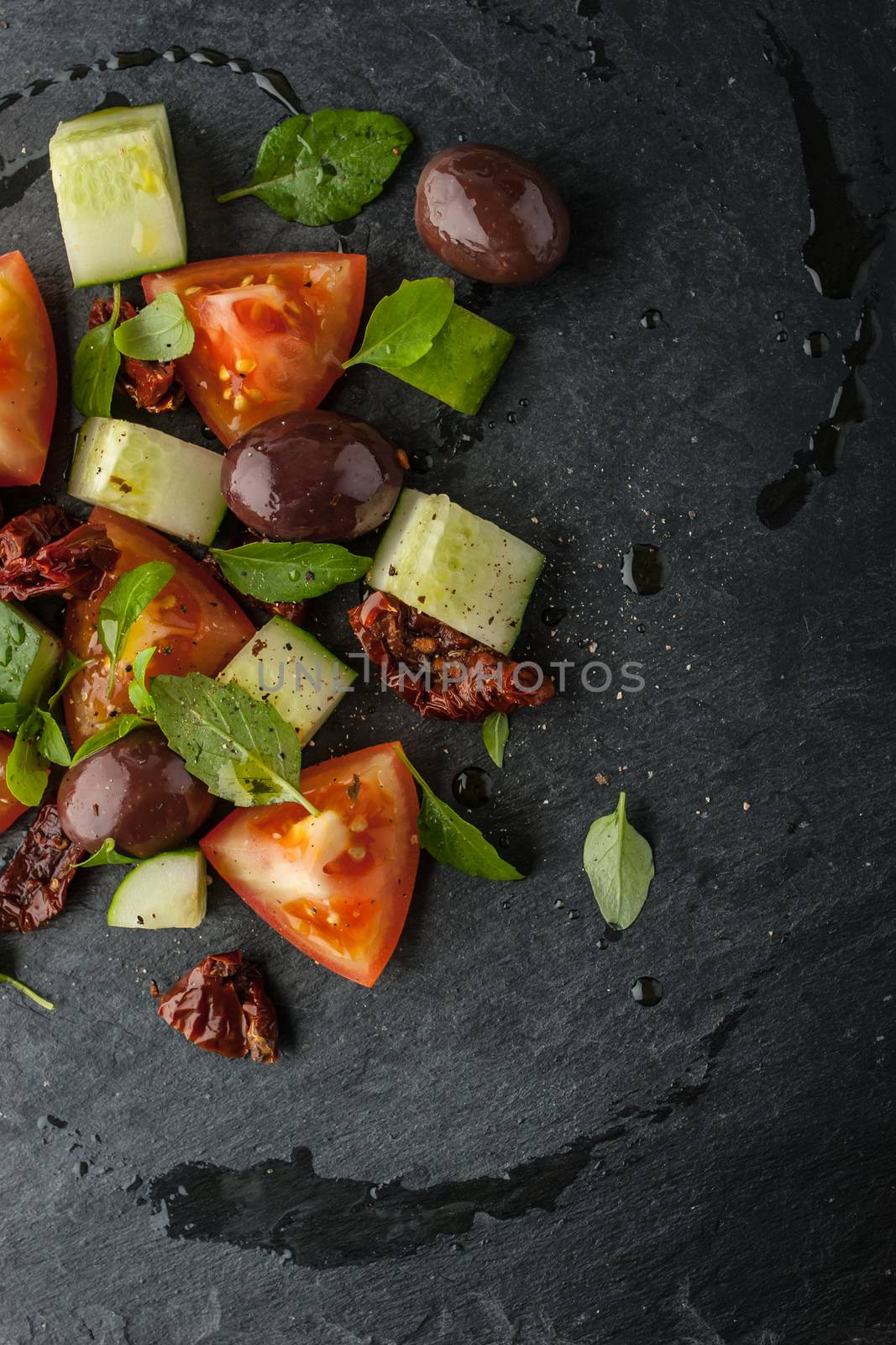 Panzanella salad on the black stone vertical