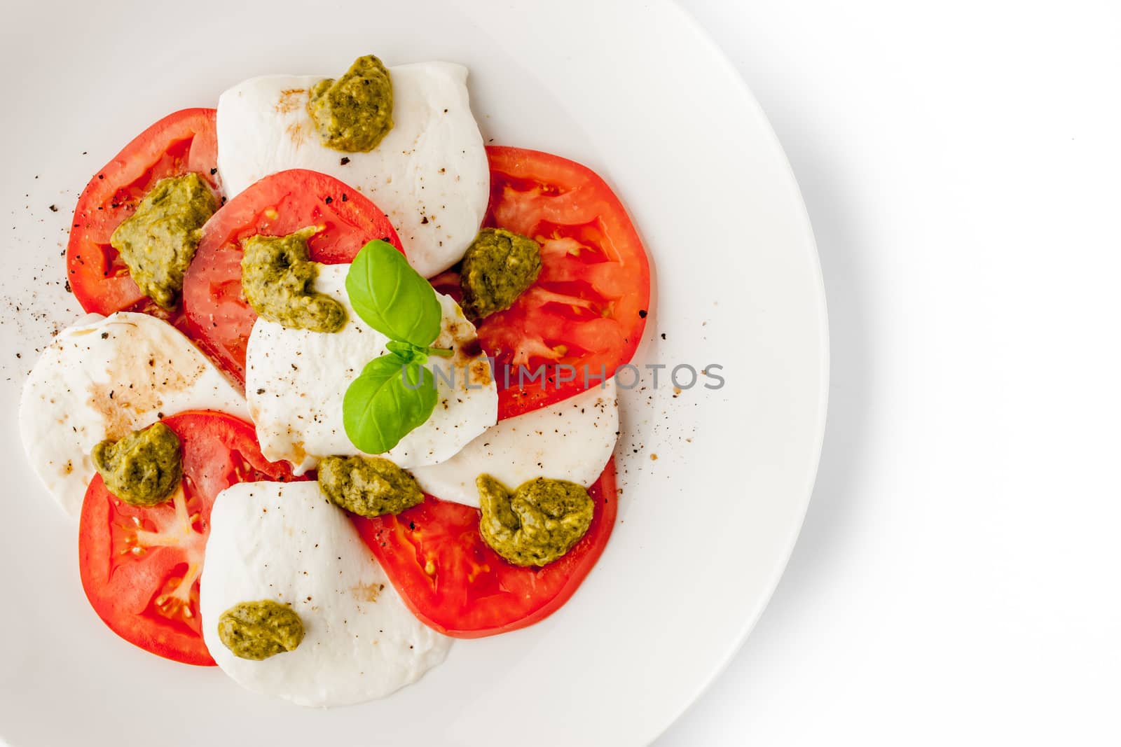 Caprese salad on the white background top view