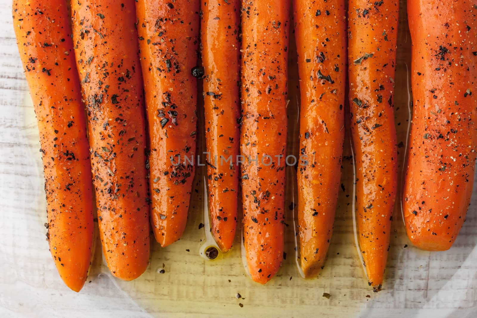 Top of baked carrots with black pepper and herbs