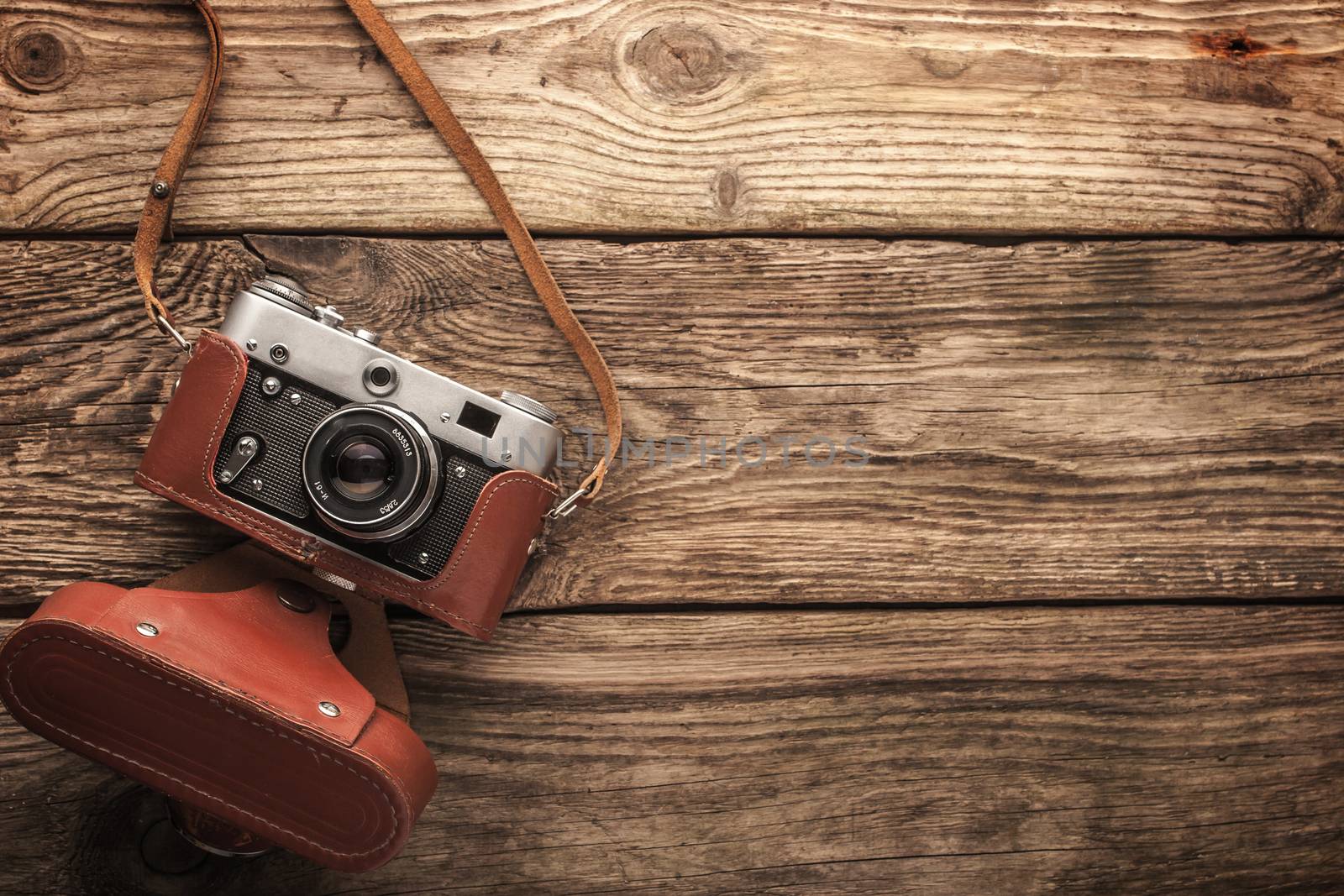 Old vintage camera on the wooden background horizontal