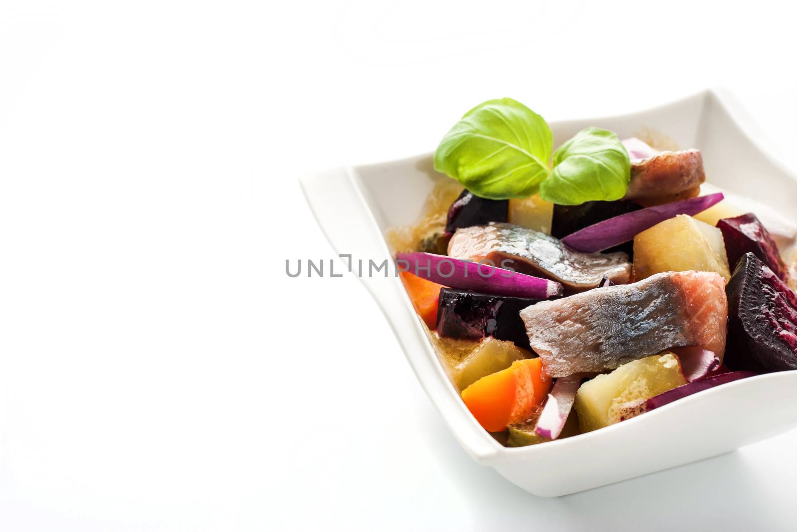 Herring and beet salad on the white dish  horizontal