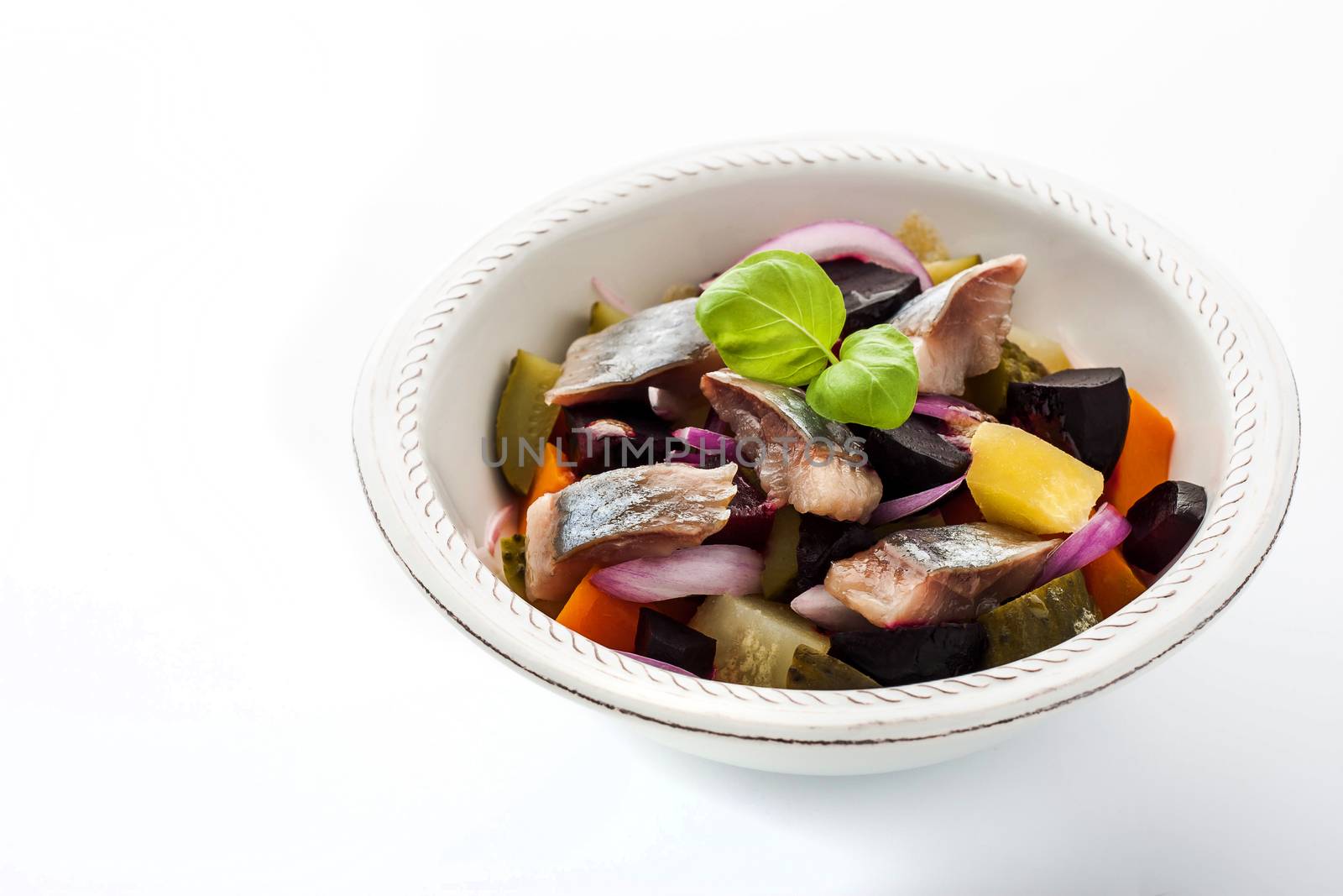 Salad with beet and herring on the white background