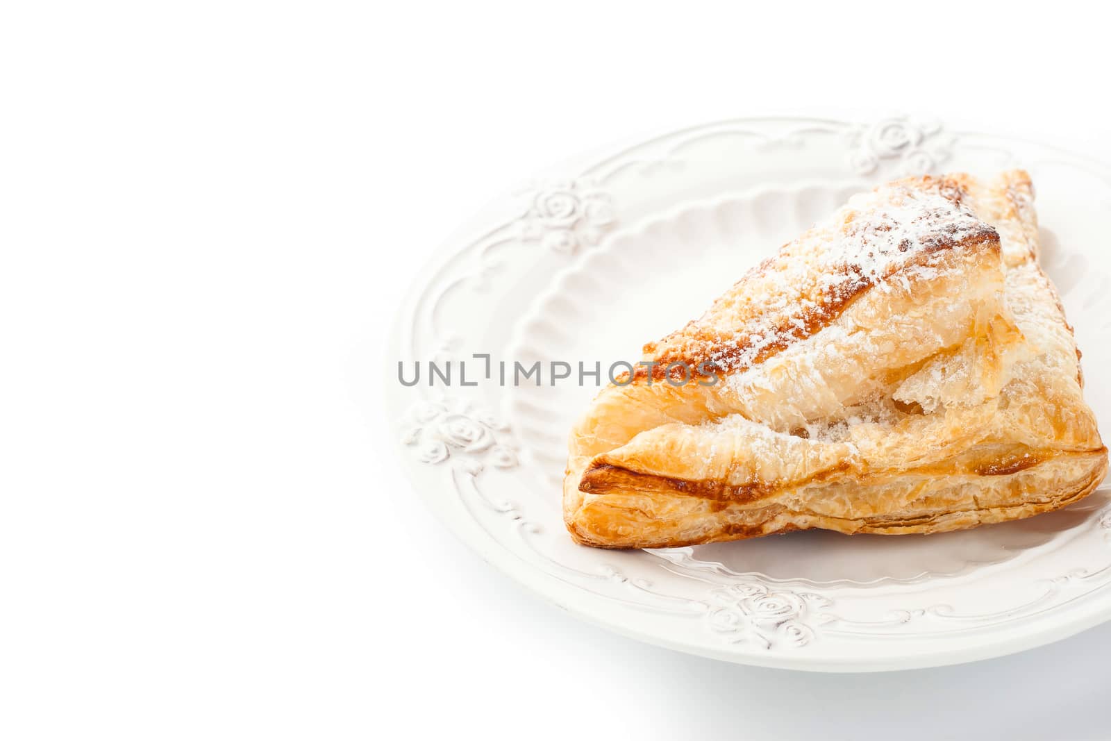 Cream puff with powdered sugar on the white plate horizontal
