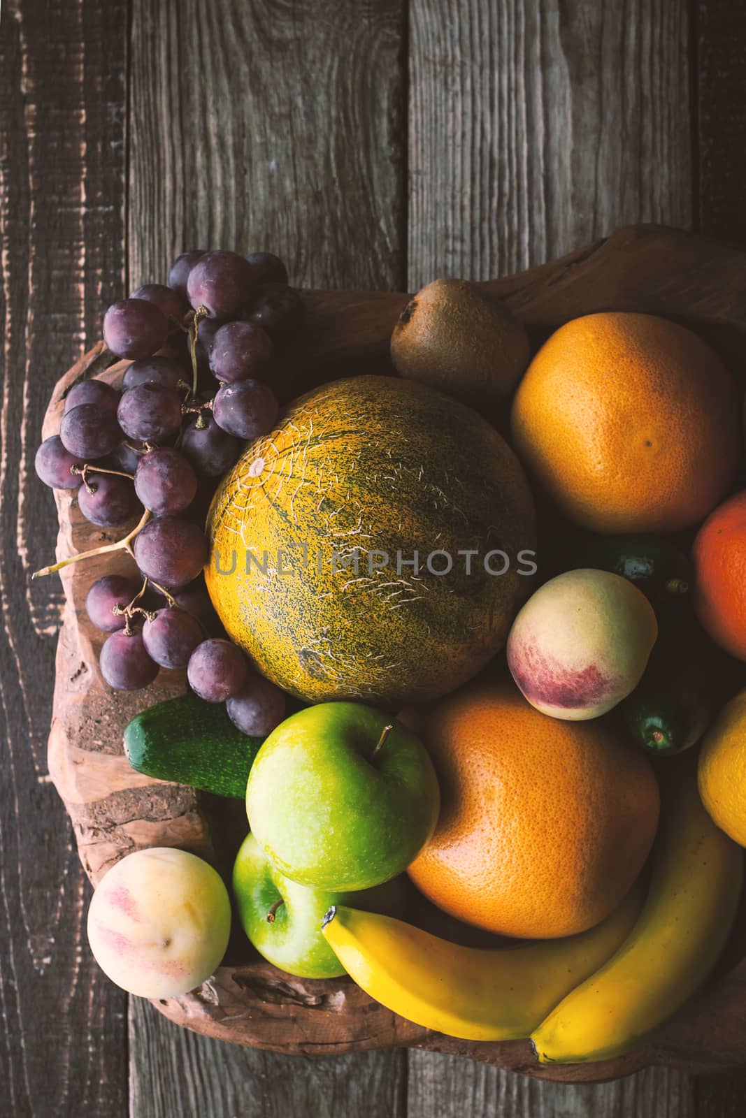 Fruit mix on the wooden bowl top view by Deniskarpenkov