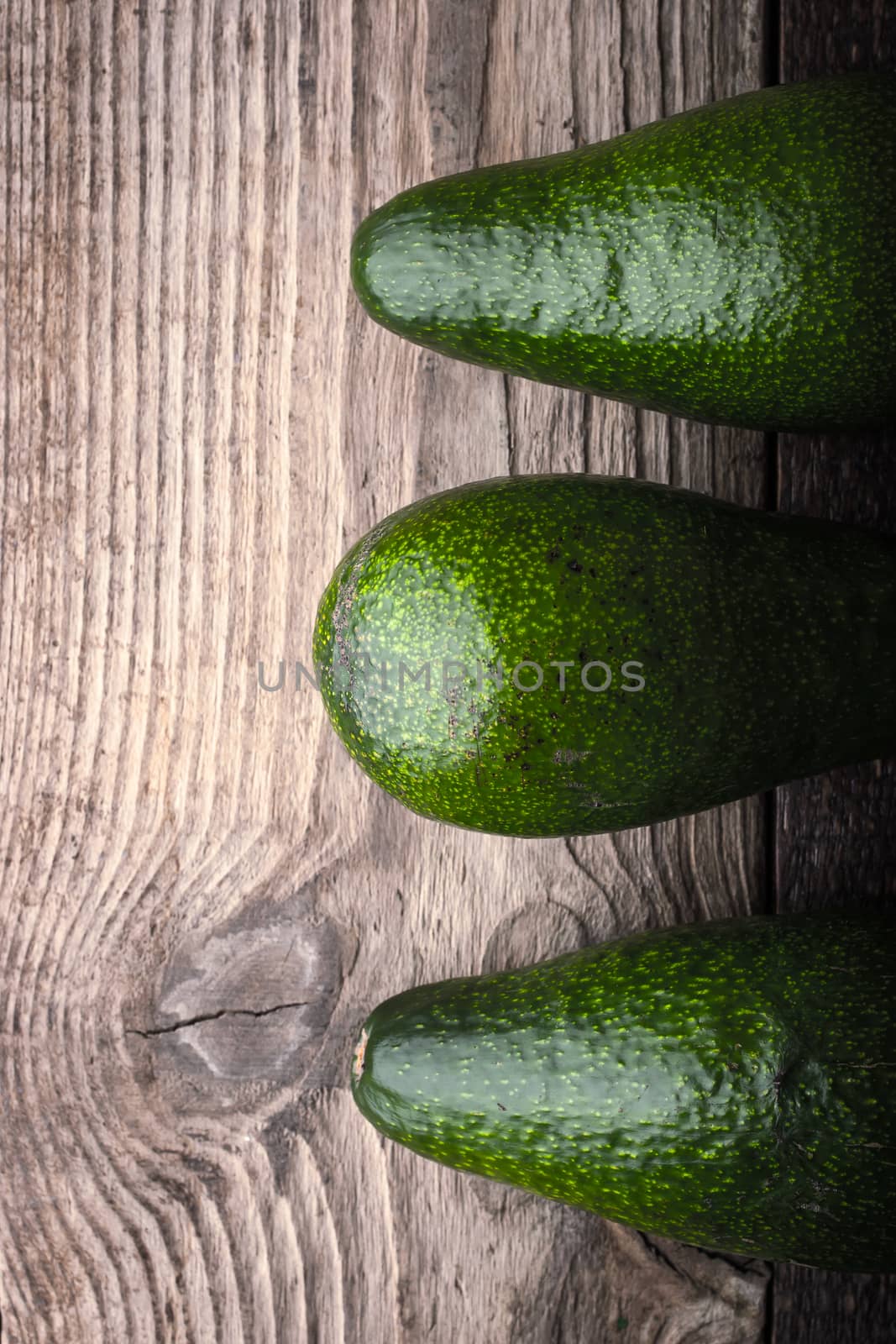 Avocado on the wooden table top view