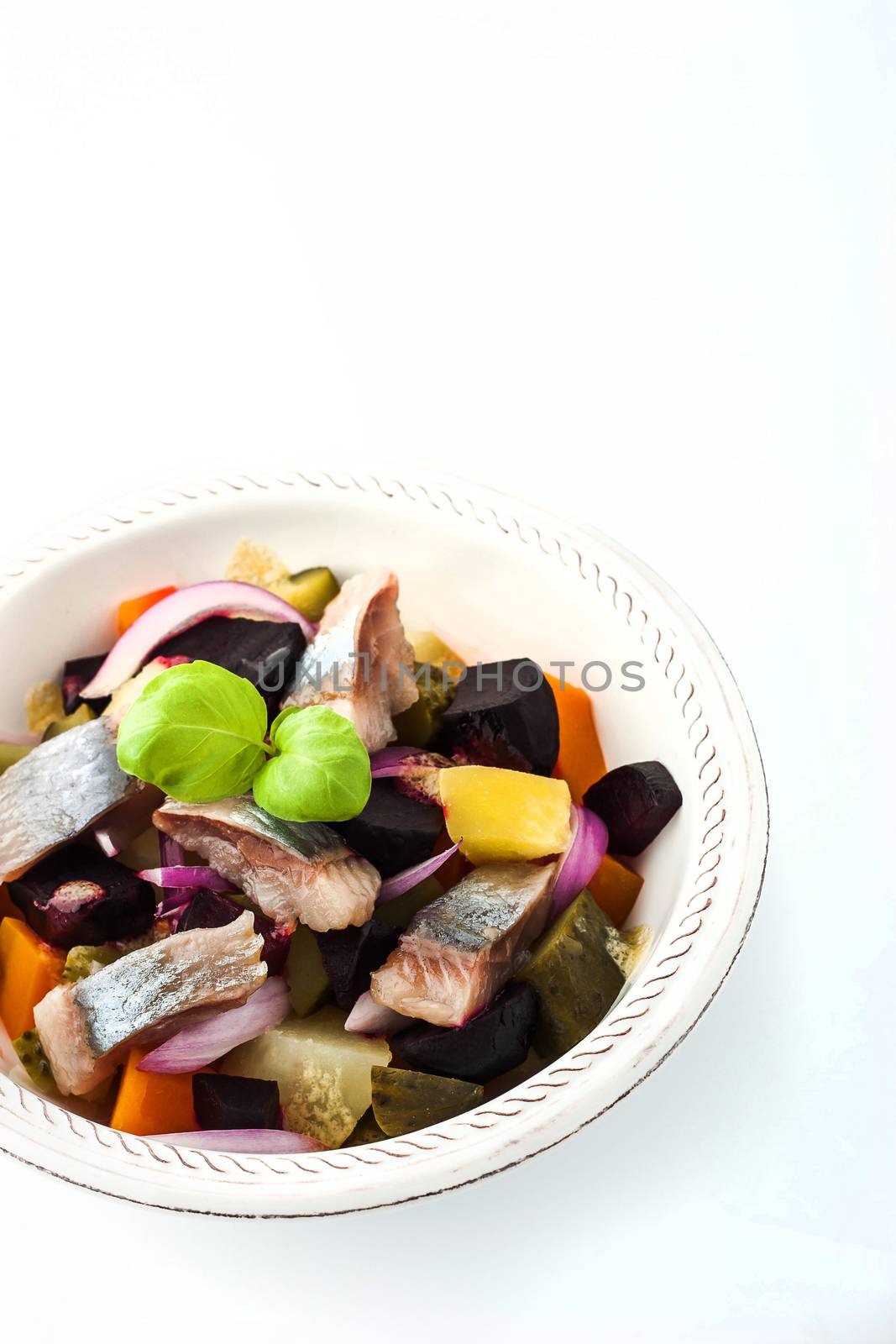 Beet and herring salad on the white dish by Deniskarpenkov