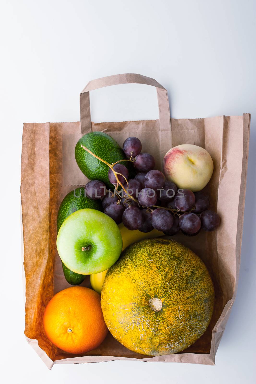 Different fruit inside a paper bag