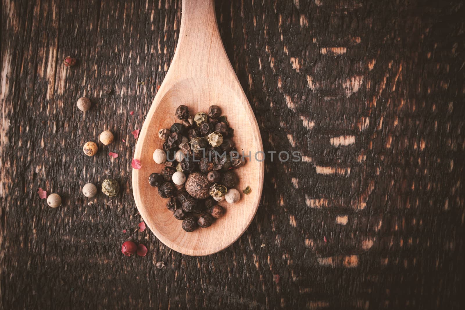 Pepper mix on the wooden spoon top view