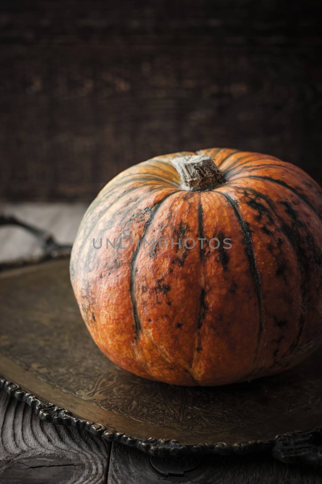 Orange pumpkin with green stripes by Deniskarpenkov