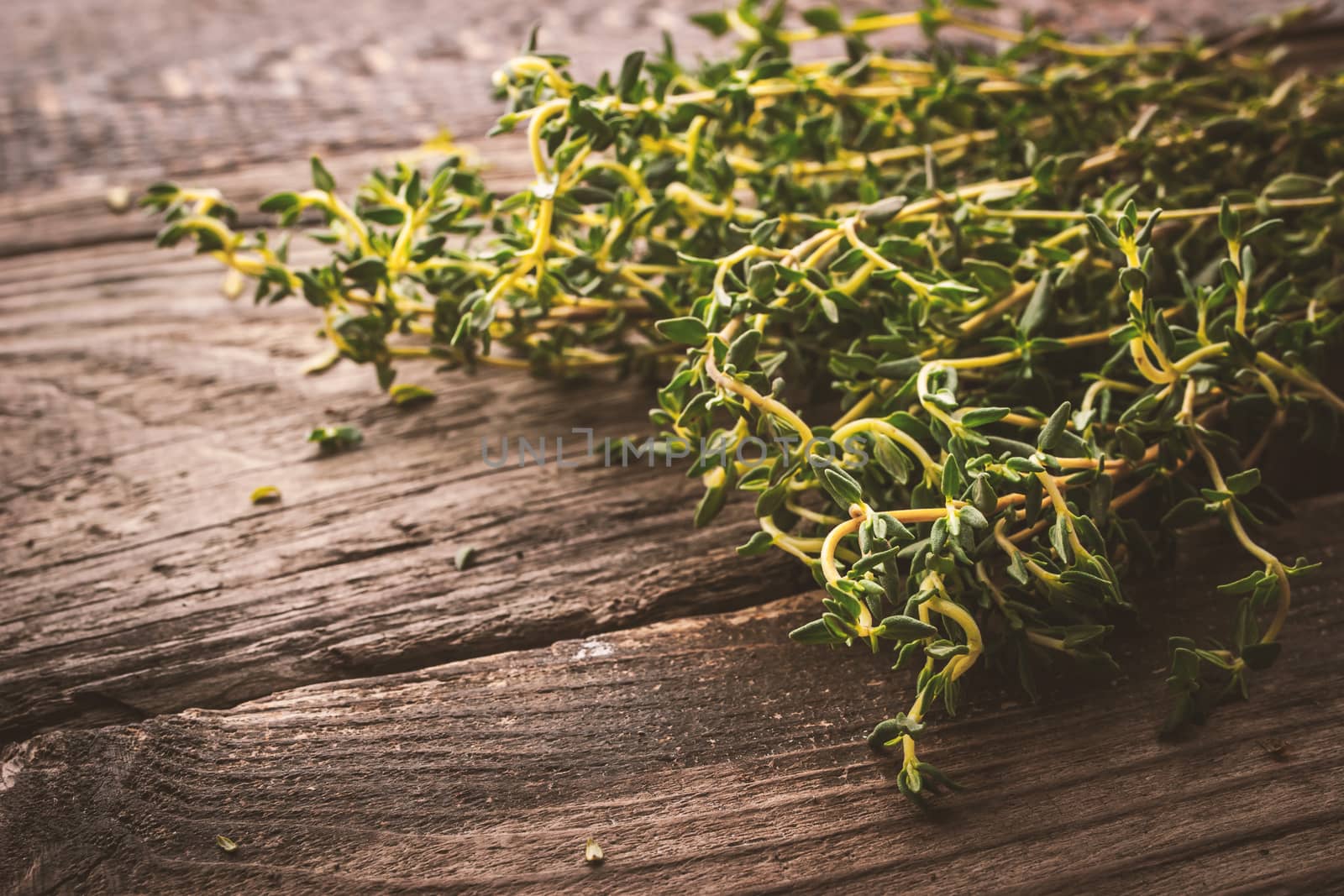 Bunch of thyme on the old wooden board horizontal