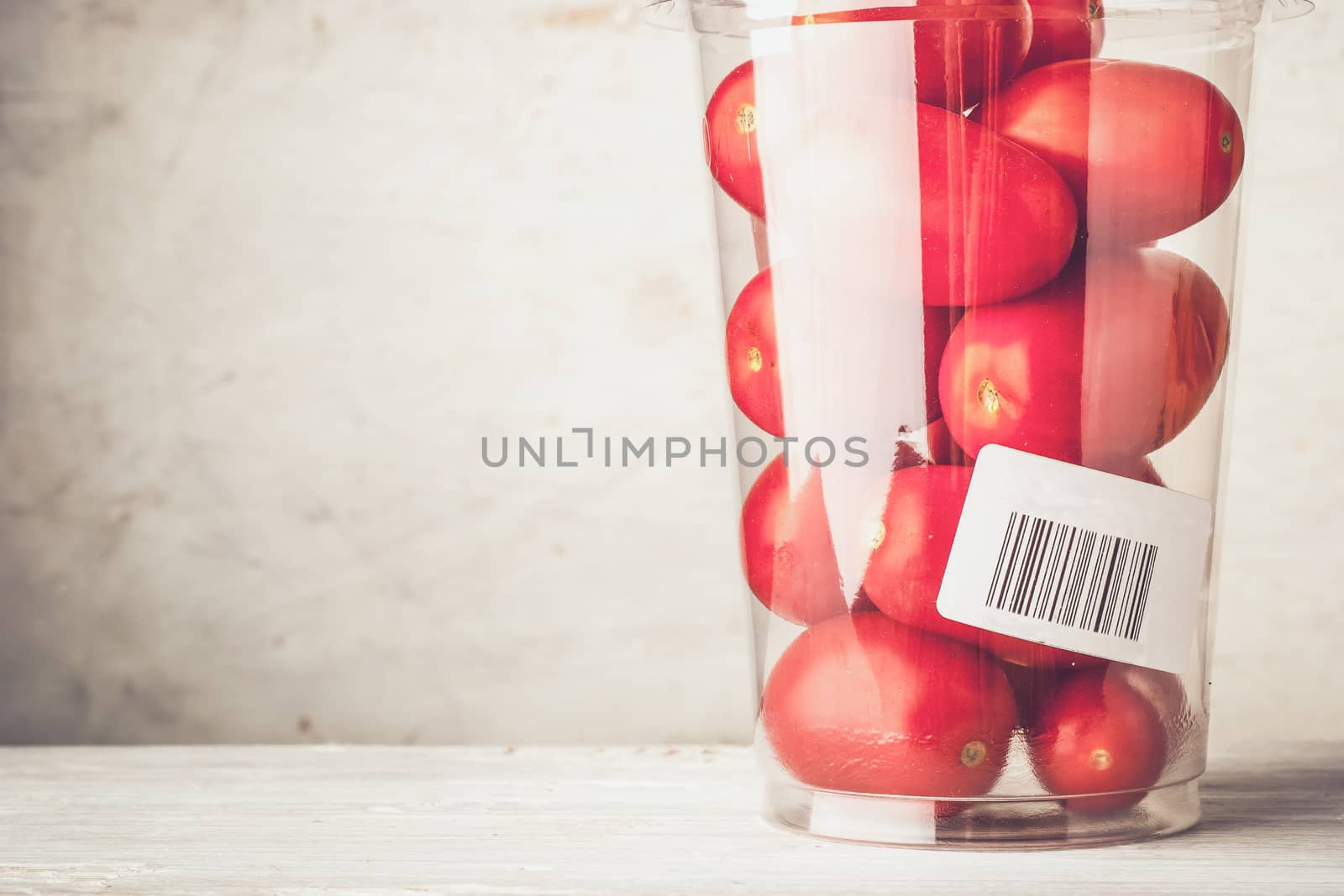 Tomatoes in the plastic container by Deniskarpenkov