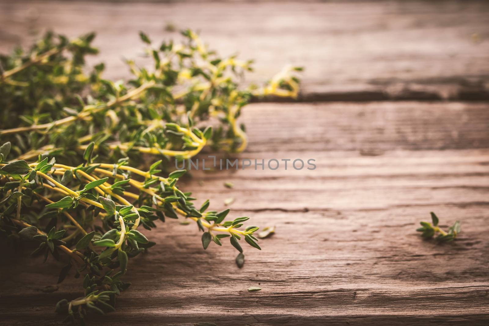 Bundle of thyme on the old wooden board