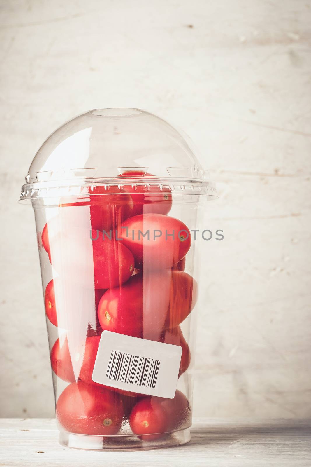 Tomatoes in the plastic package vertical