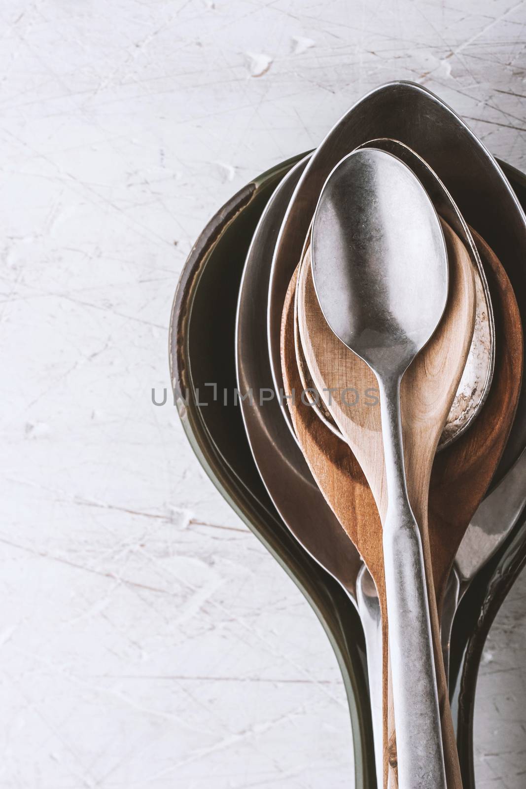 Different spoons on the  white table vertical