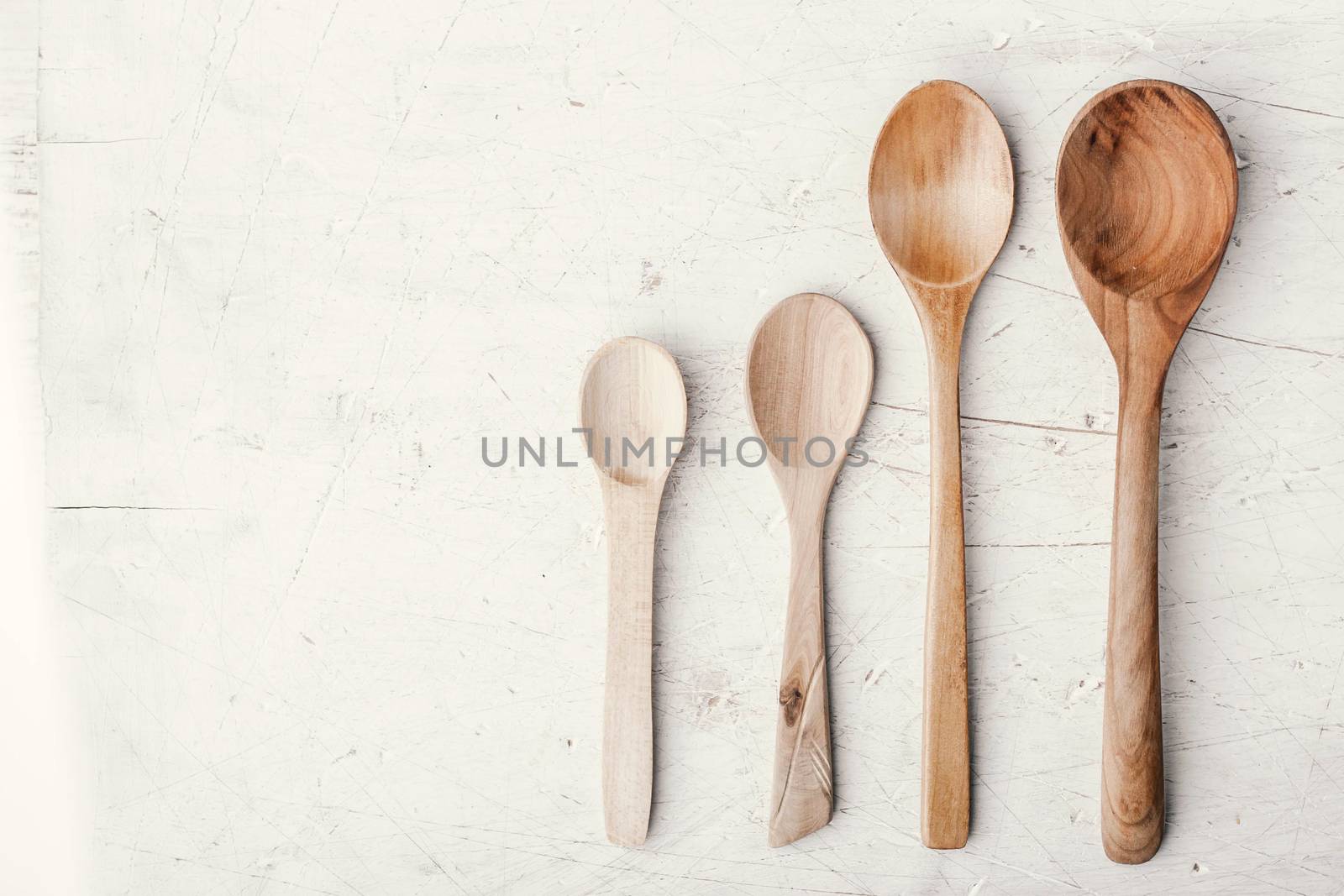 Wooden spoons on the white table top view