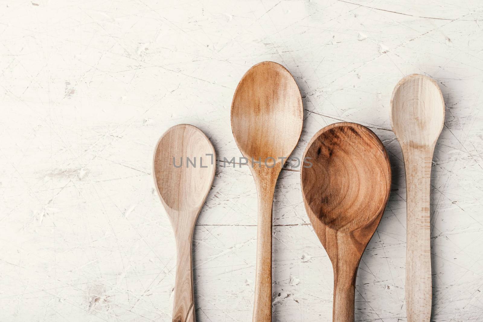 Wooden spoons on the white table horizontal