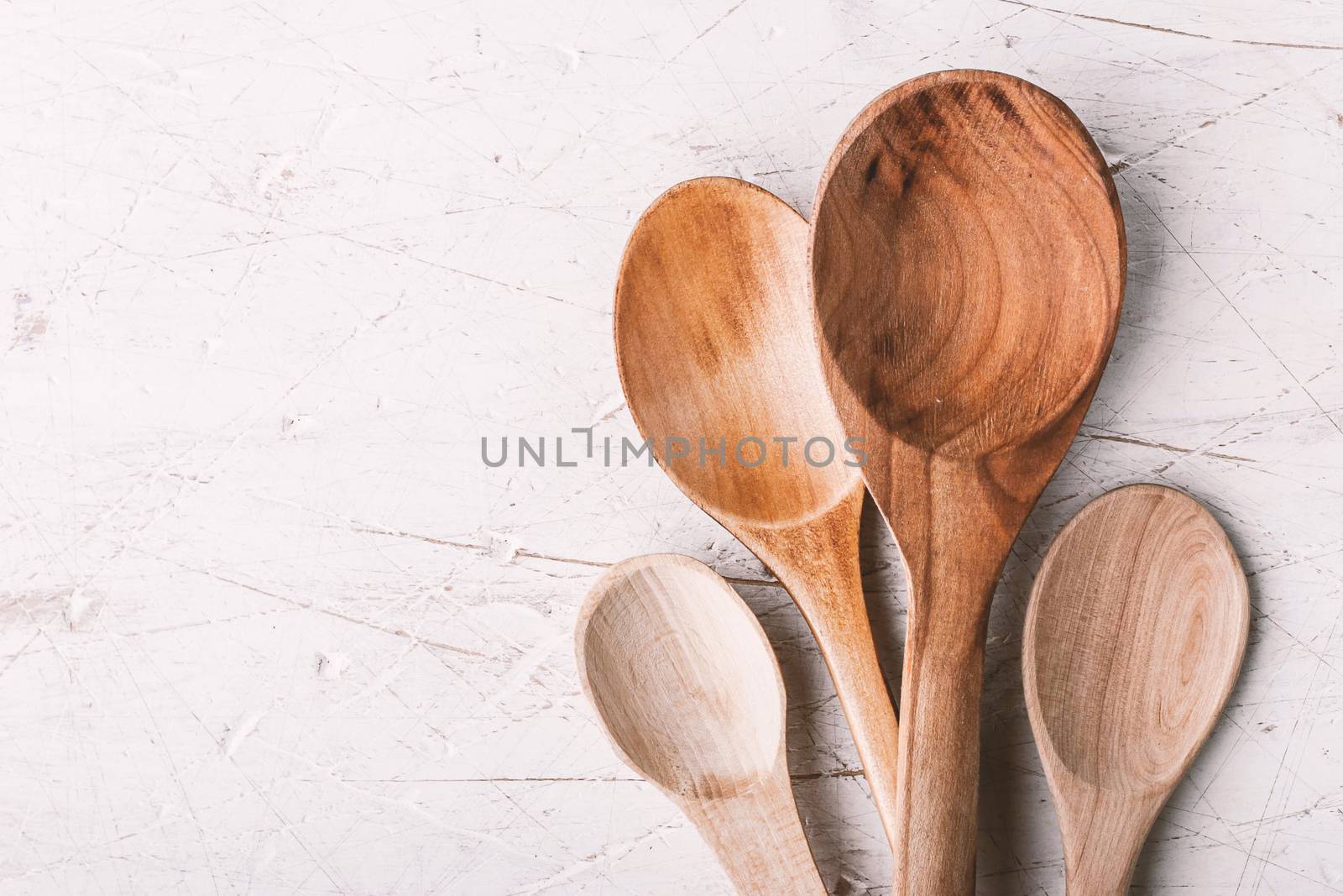 Different wooden spoons  on the white table