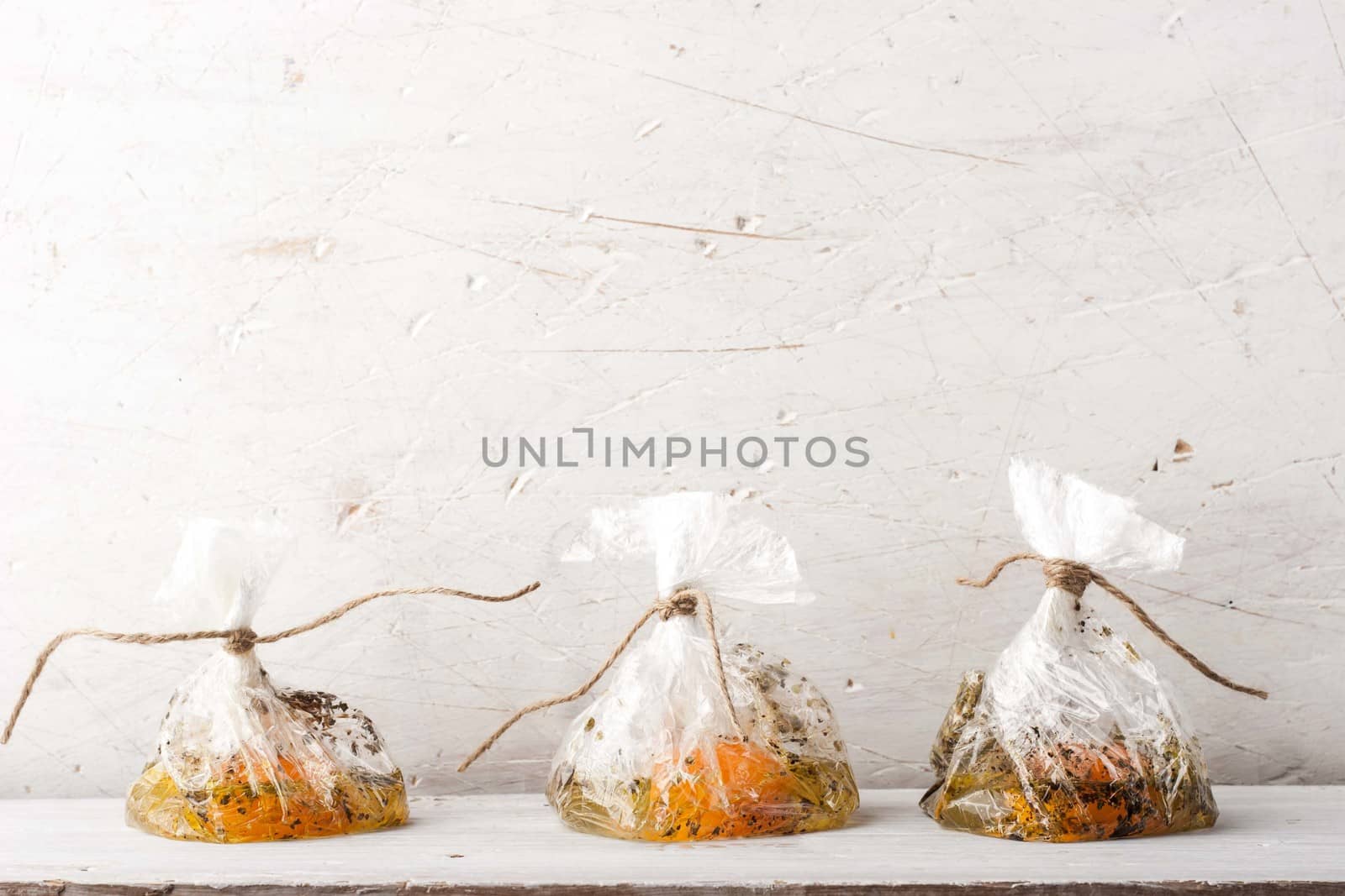 Raw eggs with seasoning in the transparent bags