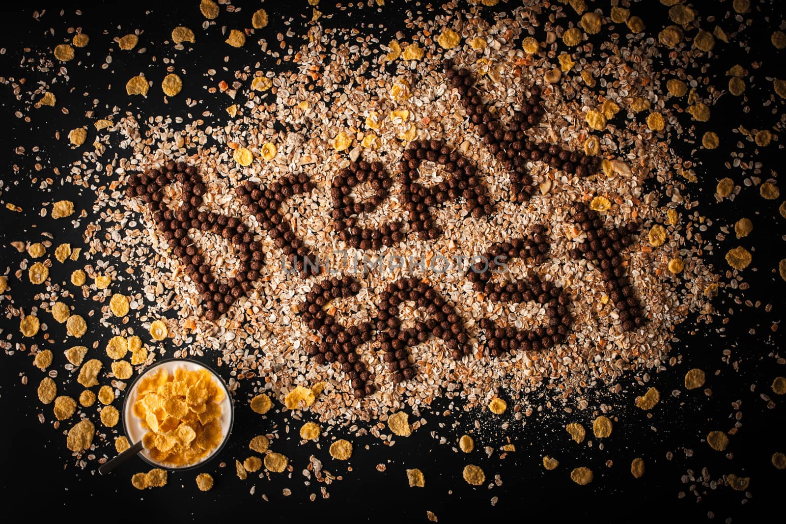 Breakfast word made by chocolate crispy ball on the muesli background