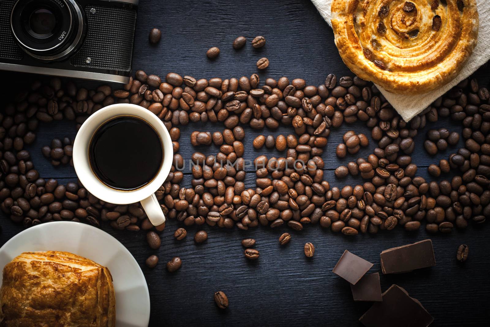Coffee word made by coffee beans with camera  chocolate , pastry and cup of coffee