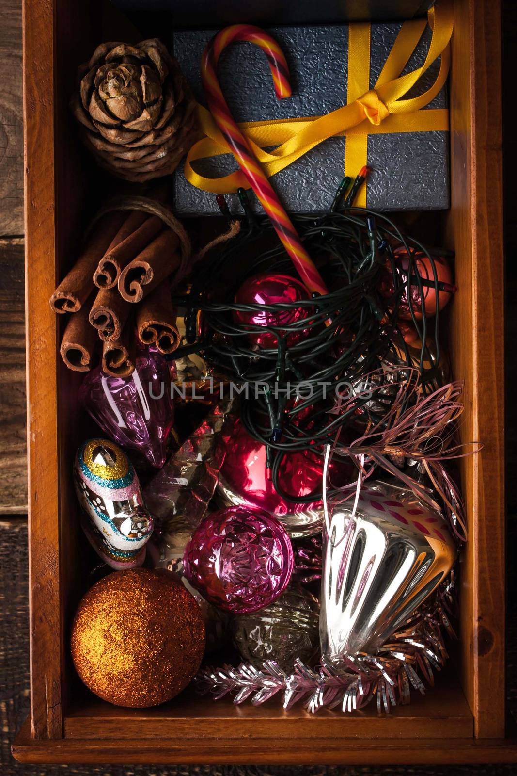 Wooden box with Christmas decorations and gift vertical