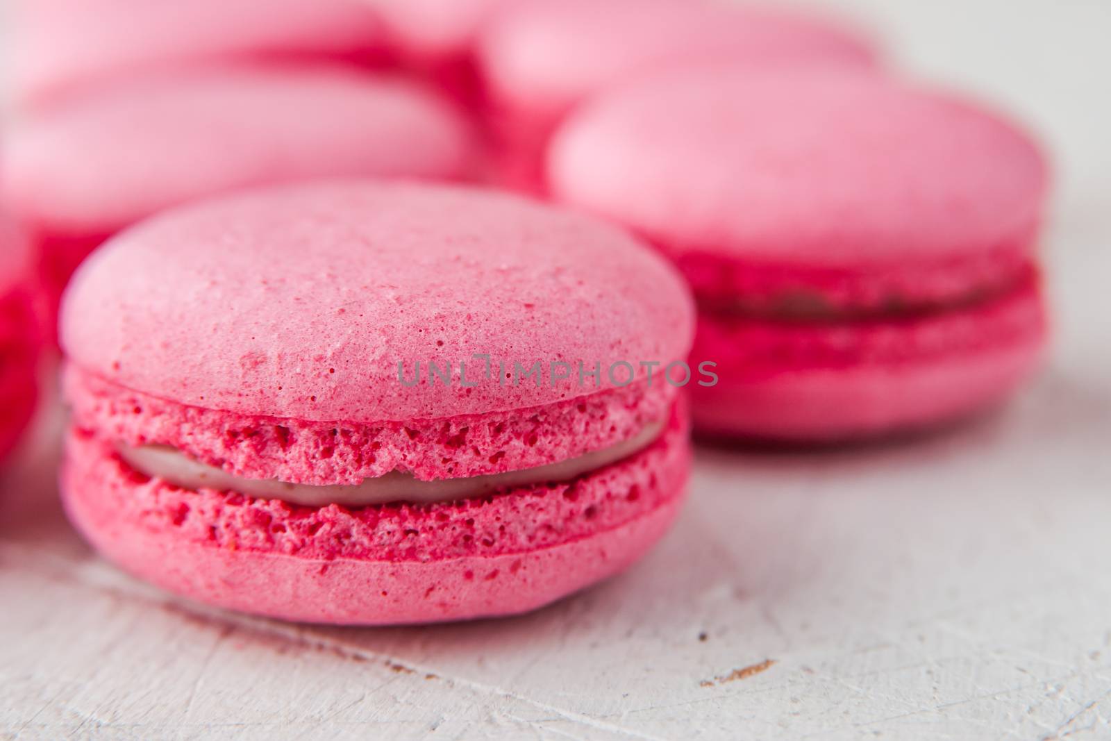 Pink macaroon on a white table horizontal