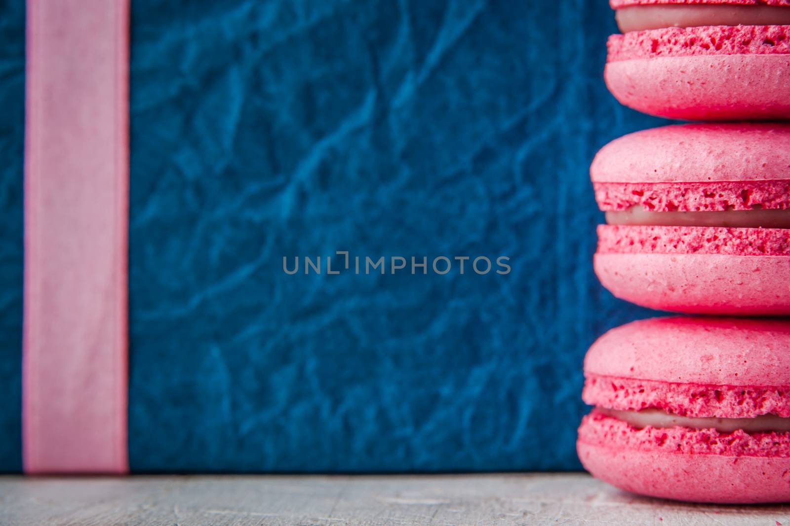 Pink macaroon on a blue background horizontal