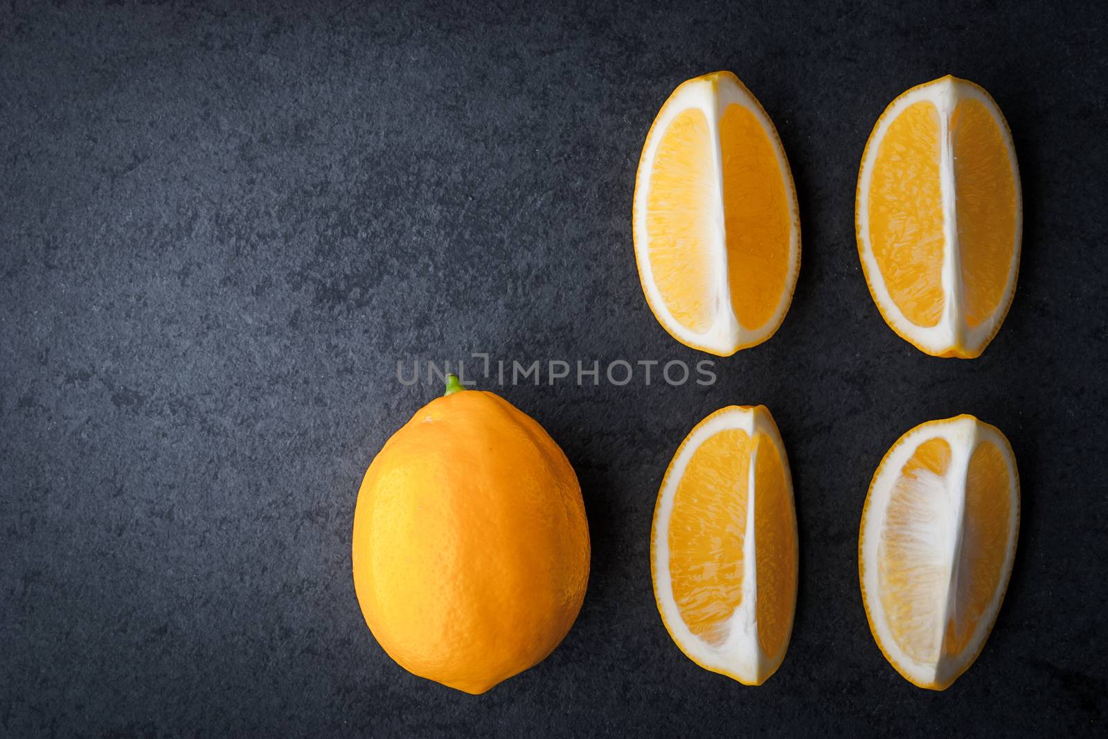 Slices of lemon on a stone table horizontal