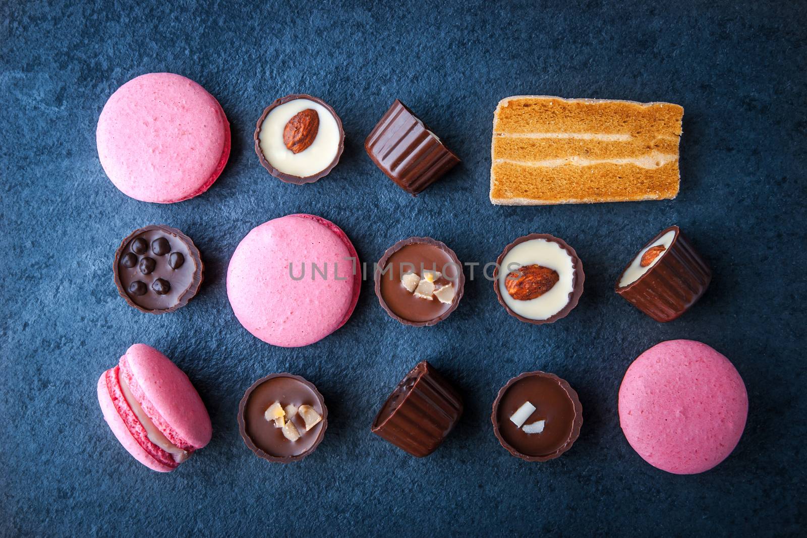 Composition from chocolates and pink macaroon horizontal, super still life