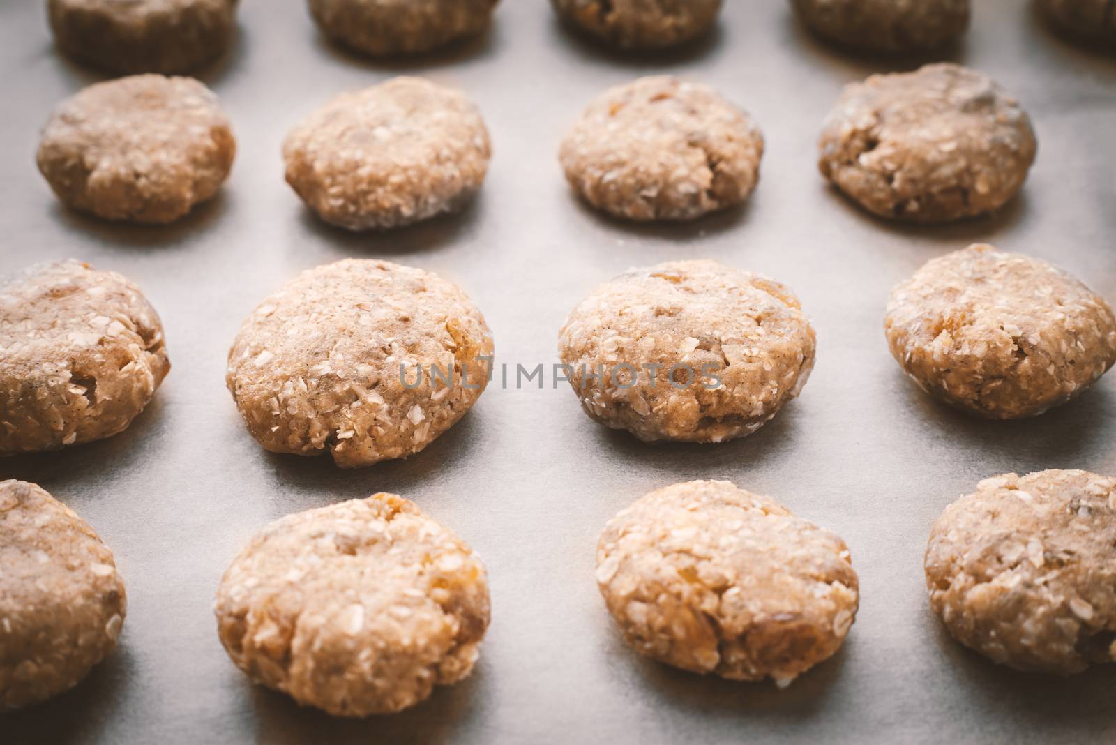 Oatmeal cookies on a baking sheet covered with parchment horizontal